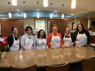 alt="TPTM team members posing for a photo in the kitchen of the Ronald McDonald House in Red Deer"