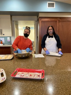 alt="Sarah and Julie preparing food at the Ronald McDonald House"